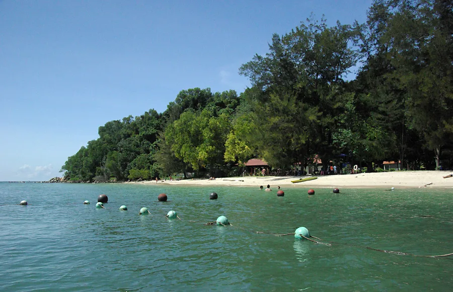 Sandy beach and shallow water at Mamutik Island in Tunku Abdul Rahman Park.