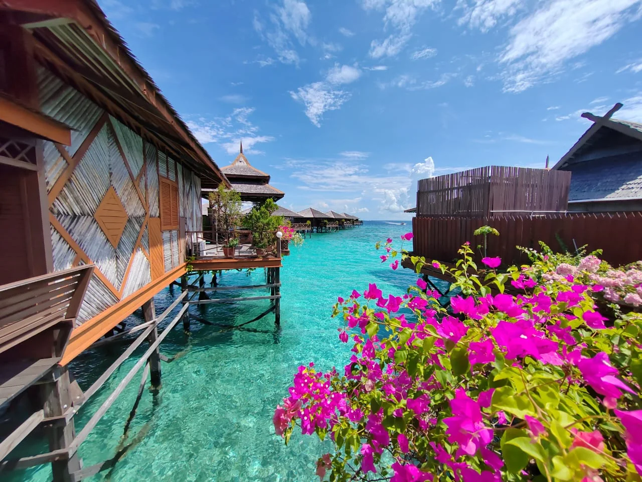 Water bungalows above clear blue water near Semporna